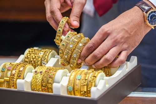 Gold dips marginally, silver drops near 2 pc as US dollar gains
