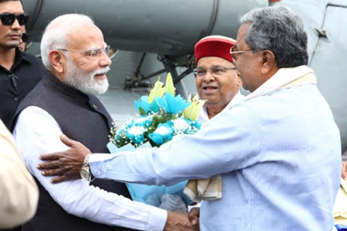 PM Modi, CM Siddaramaiah exchange pleasantries at airport 